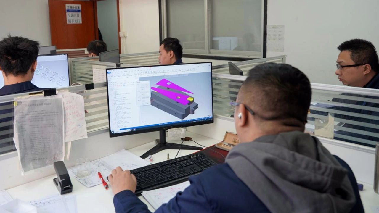 Engineer-programming-a-CNC-machine-for-custom-parts