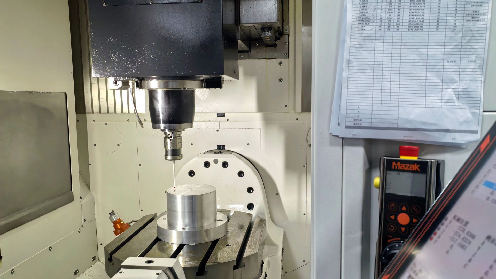 The machine tool integrated probe is performing automatic measurement during the machining process