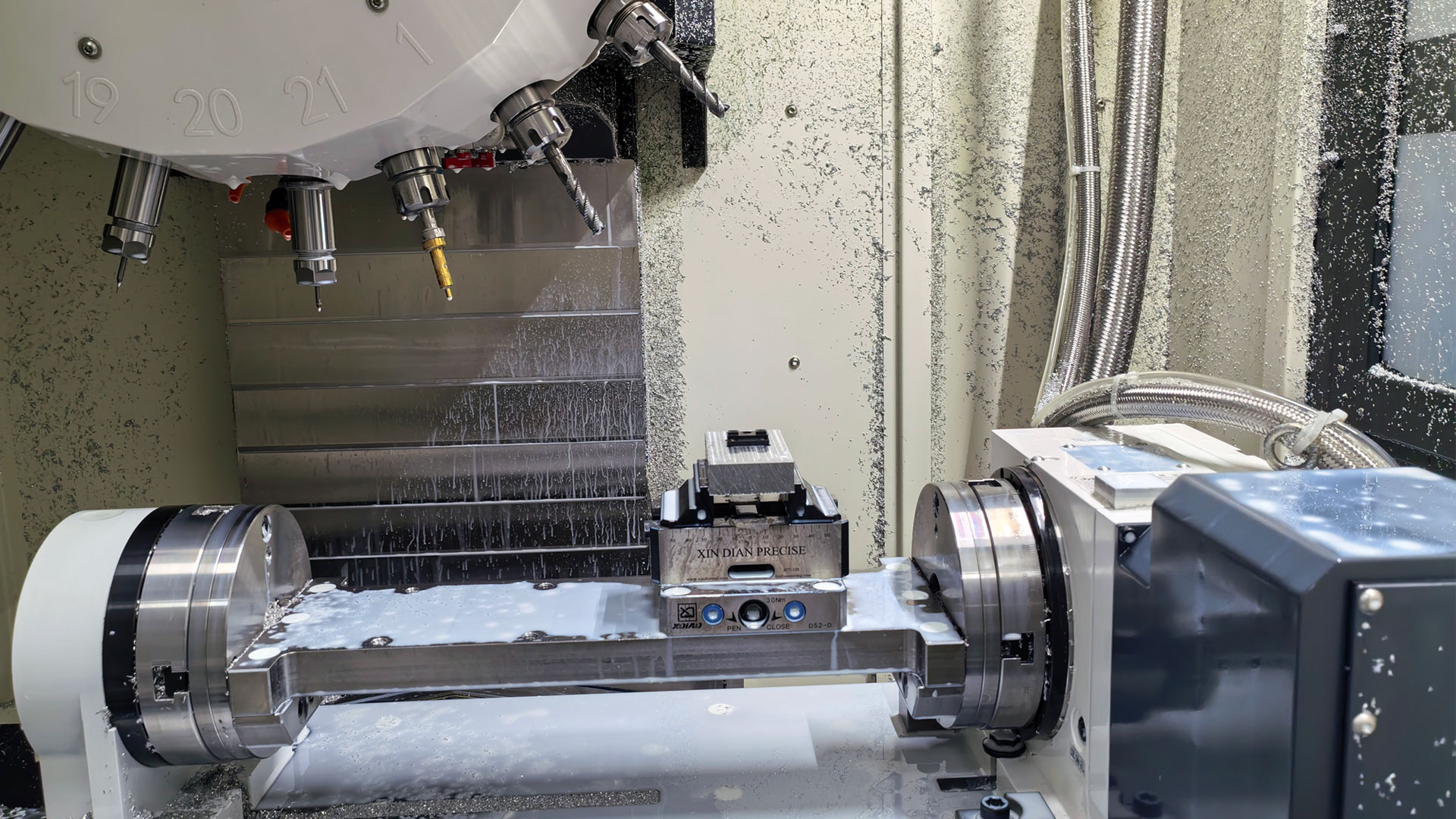 A machine tool machining a PEEK part, using an air gun for cooling