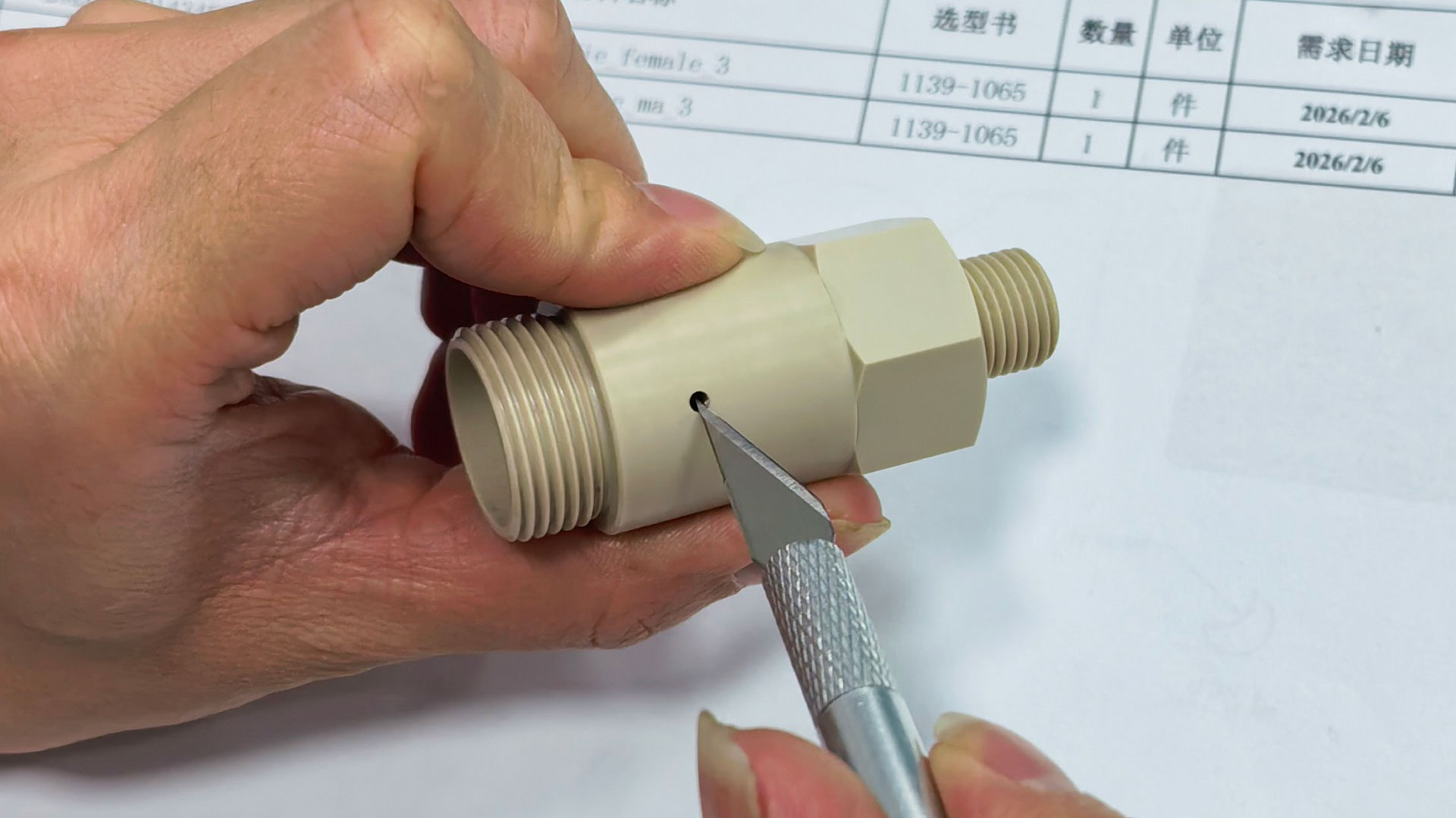 Technicians perform precise deburring and inspection of PEEK parts.